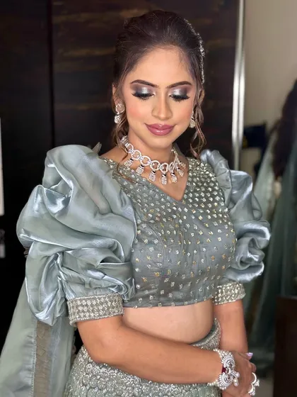Eyes closed to showcase the beautiful silver and grey smokey eye. This is a perfect example of a glamorous yet soft Sangeet makeup look.