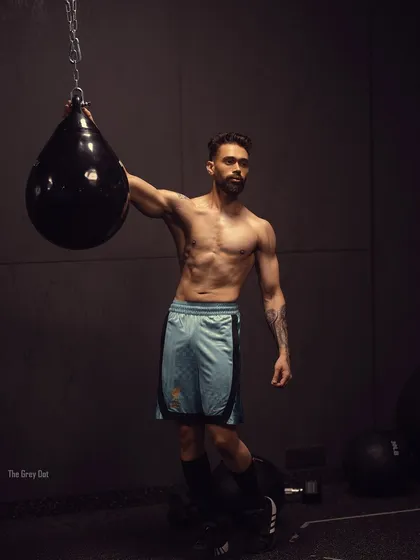 A powerful shot of me with a punching bag, captioned "Focused and fierce." This image embodies the mental strength that comes with physical training.