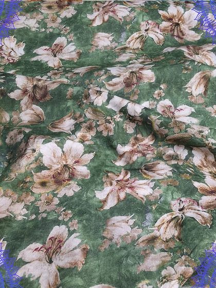A beautiful green fabric with a vintage-style floral print. This material would be perfect for stitching a classic dress or a comfortable kurti.