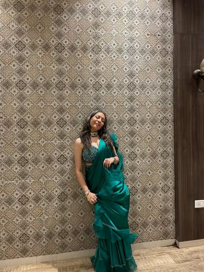Another look at our client shining in the green ruffle saree. It's a guaranteed head-turner.