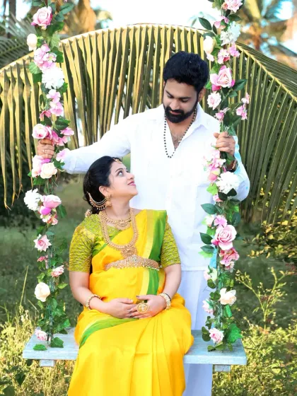 An outdoor traditional shoot with the couple sharing a moment on a floral swing. The natural setting and their loving interaction make for a beautiful and romantic memory.
