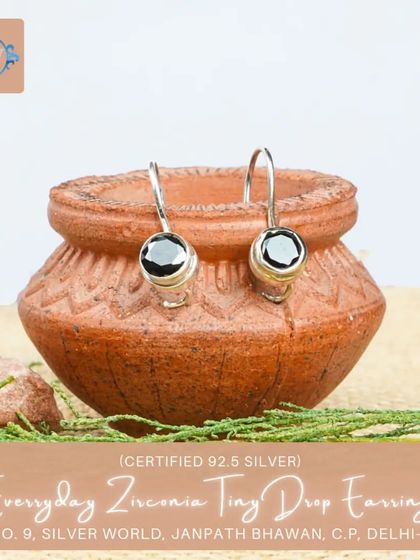 These tiny drop earrings feature a single black zirconia stone, offering a minimalist and chic look for everyday wear.