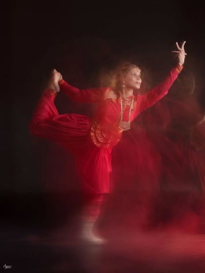 This motion blur shot captures a graceful backbend, with the red fabric creating a beautiful trail of light. It's a technique I use to convey the energy and soul of the performance.