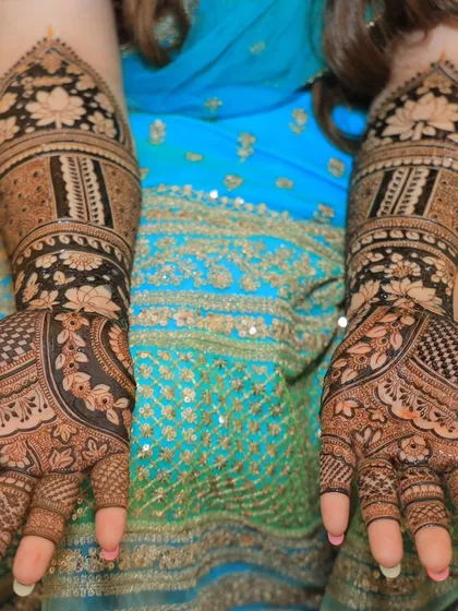 A classic, full bridal mehendi design showcasing the rich, dark stain from my 100% herbal paste. The symmetrical patterns and intricate details, including lotus motifs, are designed to adorn the bride's hands beautifully.