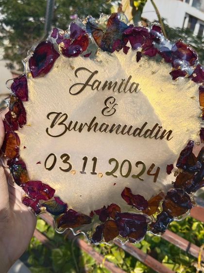A different view of the wedding keepsake plaque, highlighting the rich texture of the preserved rose petals and the elegant script of the custom text.