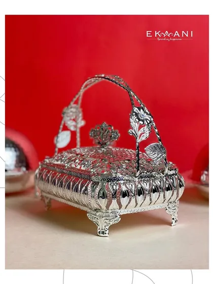 The lidded view of our rectangular silver basket shows off the detailed craftsmanship on the handle and lid. It is perfect for keeping sweets or savories fresh while being displayed beautifully.