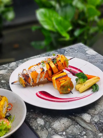 A perfect brunch plate. Grilled cottage cheese skewers with a side of corn salad, enjoyed in the fresh air of our garden.