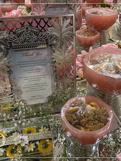 This pastel pink hamper is a delicate and grateful way to thank wedding guests. The combination of the silver frame, dry fruit bowls, and sweets is always a cherished choice.