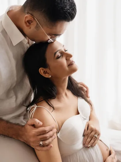 Such a sweet and loving gesture. A kiss on the forehead is one of my favorite prompts for couples. It creates such a natural and emotional moment, perfect for a maternity photoshoot.