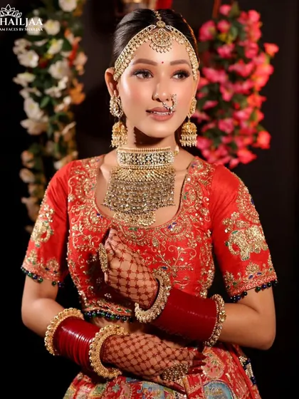 This bride is ready for her big day in a vibrant red lehenga. I created a glowing, dewy makeup look with defined eyes and a neutral lip to complement her modern jewelry and ensure she shines.