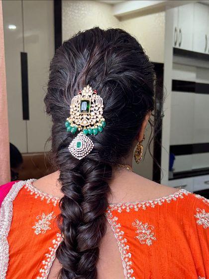 A detailed shot of the intricate hair accessory on a perfectly executed fishtail braid.