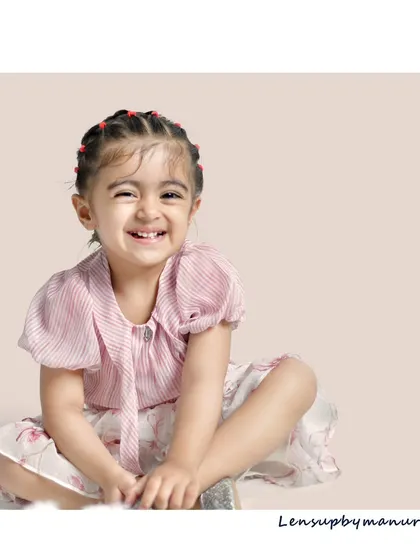 A beautiful, simple portrait of a toddler with a bright, scrunchy-nosed smile. These sessions are perfect for capturing the emerging personality and pure happiness of your growing child.