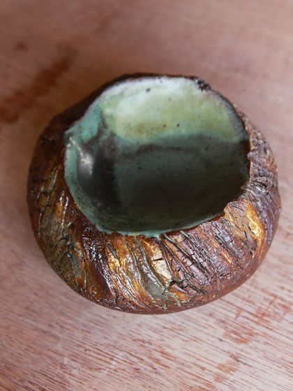 This small, textured bowl has a beautiful, almost metallic sheen from the glazes. It's a testament to the endless possibilities of experimentation in an electric kiln.