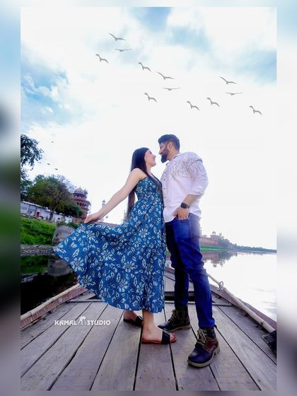 A playful, candid moment on a boat with the Taj Mahal in the background. This perspective offers a unique and serene view, perfect for capturing relaxed and joyful interactions.