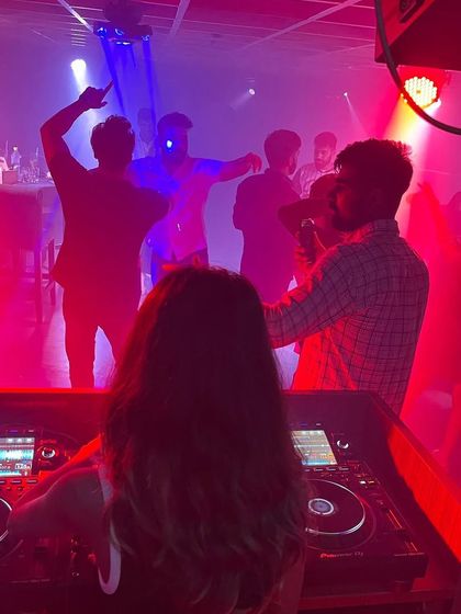 A view from my console in Dehradun. I love watching the crowd get lost in the music under the red lights.