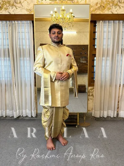 This is the classic South Indian groom's 'Muhurtam' look, made with pure silk. I designed this custom Jodhpuri-style kurta and 'kacche' (dhoti) to feel both traditional and elegant. The focus was on subtle, clean embroidery on the collar and cuffs, paired with a beautiful 'shalya' (shawl) with pure zari for that perfect ceremonial finish.