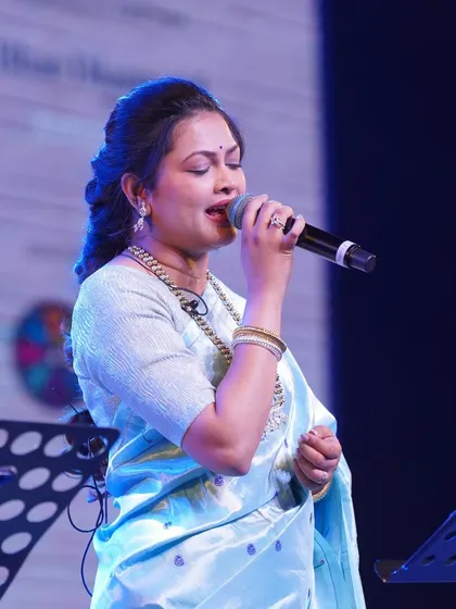 A close-up of Priyanka Barve on stage, showing the delicate silver work on her blouse and the traditional Paithani motifs.