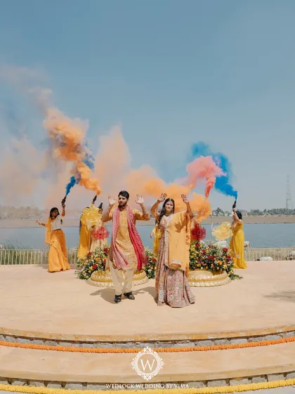 A burst of color and joy for a fun-filled Haldi ceremony by the water. We love creating these high-energy moments with vibrant decor and playful elements like color bombs that make for unforgettable memories.