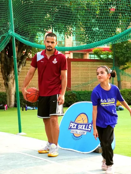 My role as a coach goes beyond drills and strategy. It's about mentorship and skill development. Here, I am with a young player, providing the personalized guidance that helps build both a better athlete and a more confident individual.