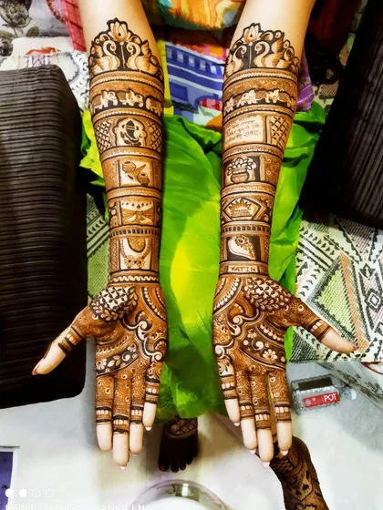 A full-arm design showcasing a variety of traditional Indian motifs. We included Lord Ganesha, a doli (palanquin), and the auspicious half-moon symbol for a complete bridal story.