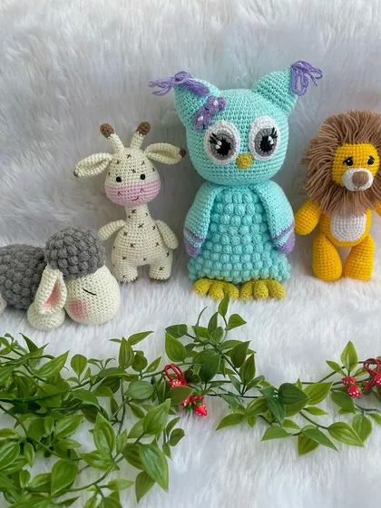 A beautiful collection of baby's first toys, including a gentle giraffe, a wise owl, and a brave lion. All are made with baby-safe materials.