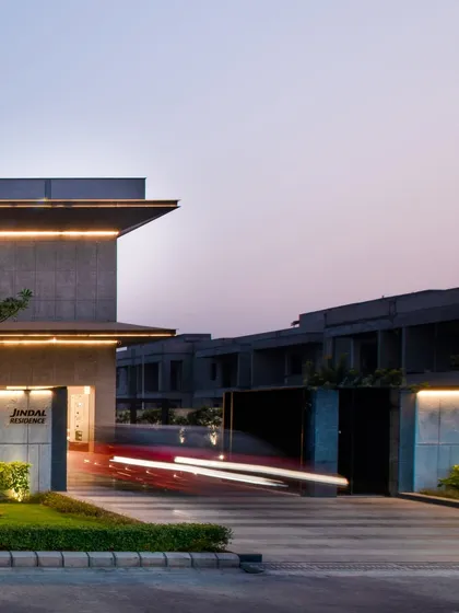 The entrance gate of the Jindal Residence, captured with long-exposure photography to show motion. The design of the entrance is modern and understated, setting the tone for the entire property.