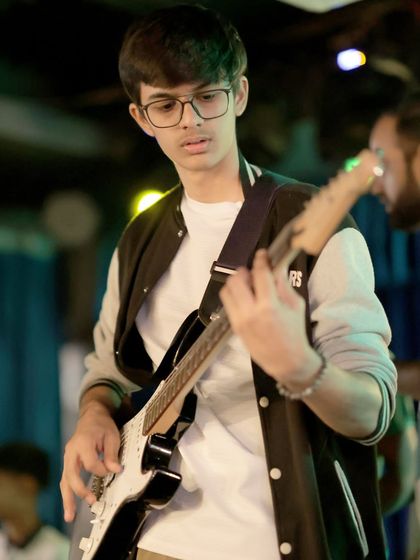 Looking every bit the rockstar, this student performs on his electric guitar. Our band coaching helps students live out their musical dreams.