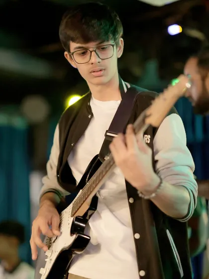 Looking every bit the rockstar, this student performs on his electric guitar. Our band coaching helps students live out their musical dreams.