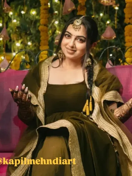 A stunning client at her mehndi event. The dark, rich color of her henna looks beautiful against her olive green outfit.