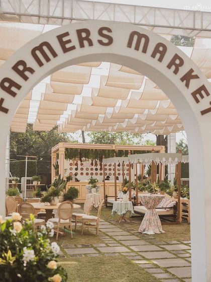 The main entrance arch for the 'Farmers Market' brunch, welcoming guests into a charming and immersive themed experience.