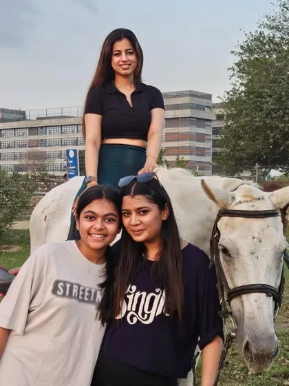 Friends gather for a photo with one of our beautiful white horses. It's all about creating good vibes and lasting memories.