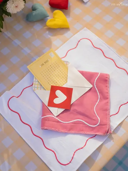 Custom-designed stationery and napkins with heart motifs add a sweet, personal touch to the picnic theme.