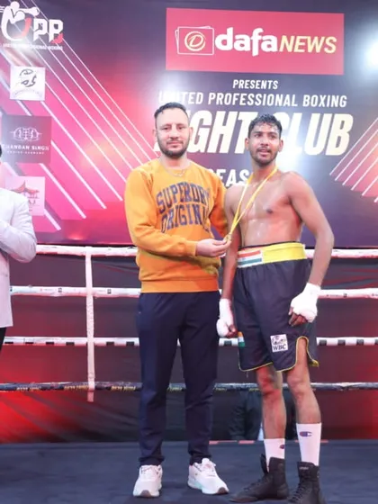 A boxer receiving his award from international champion Akshay Kumar. My fighters get exposure to the best in the sport.