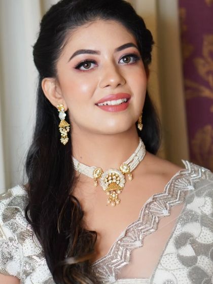 A beautiful portrait showcasing the final 'lit-from-within' look. The makeup is balanced, with defined eyes and a radiant complexion that looks both natural and glamorous.