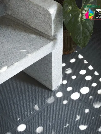 Light as art. The polka-dot shadows cast by the perforated screen are a simple yet powerful design element that brings joy and visual interest to the space.