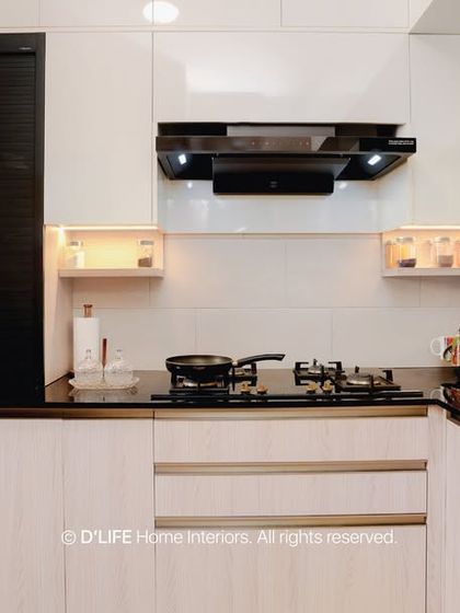This sleek modular kitchen combines white gloss cabinets with dark accents for a clean, modern look. Integrated appliances and smart storage solutions ensure the space is as functional as it is beautiful.