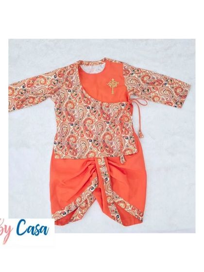A vibrant orange dhoti and paisley print kurta set. This traditional outfit is made from soft, breathable fabric, perfect for a long day of festive celebrations.