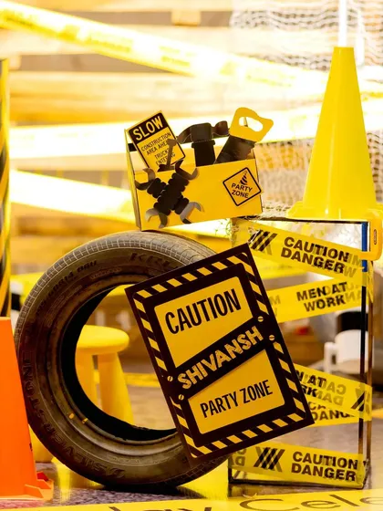 Caution: Party Zone. This vignette shows how I layer different elements like custom signs, tires, and party favor boxes to create a visually interesting and fully themed construction party environment.
