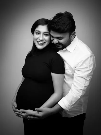 Wrapped in his arms, her smile is radiant. This black and white portrait is full of warmth and happiness. It’s a classic, timeless image that captures the security and joy of their relationship.