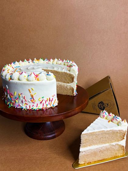 Introducing my Woah-nilla cake, also available by the slice. If you're a fan of classic vanilla cake, look no further. It's pure, no-frills vanilla goodness to end any meal on a perfect note.