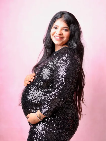 A pop of pink in the background adds a touch of softness to this glamorous shot. The black sequin dress provides a beautiful contrast and a bit of sparkle.