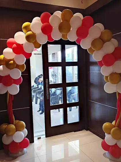 We create welcoming entrances for all kinds of family functions, including this balloon arch for a naming ceremony. The red, white, and gold color scheme provides an elegant and festive welcome for guests.