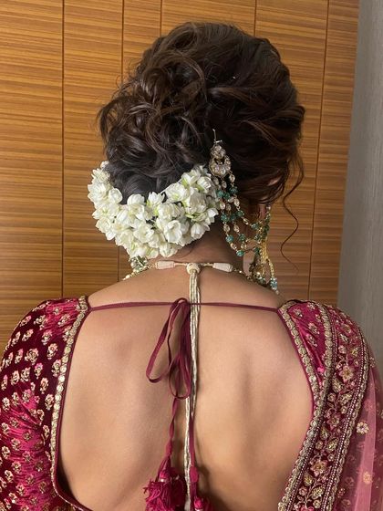 The texture in this messy bun adds a modern touch to the traditional gajra hairstyle, making it feel soft and romantic.