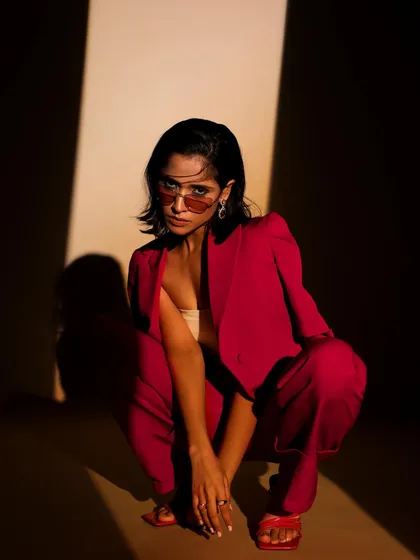 Power dressing with a twist. This look from a studio lookbook demonstrates my skill in styling contemporary formal wear, using dramatic lighting and strong poses to highlight the suit's sharp tailoring and bold color.