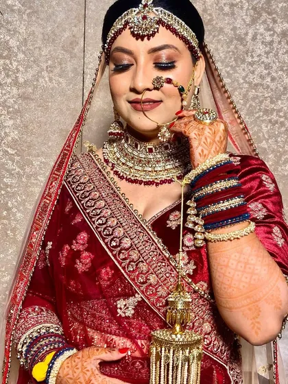 A candid moment showing the bride's beautiful smile. The makeup is set to look fresh and vibrant throughout the long day.