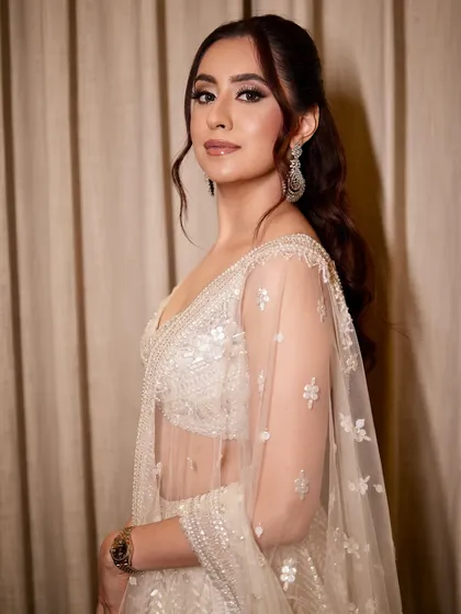 A side profile of Sehej's Roka glam, showing off the soft waves in her hair and the beautiful shimmer on her eyes.