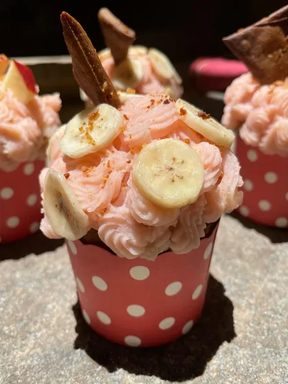 A close-up of my classic Apple Banana Cupcakes, or ABCs. That lovely pink frosting gets its color from natural beetroot juice, and it's topped with fresh banana and apple slices.