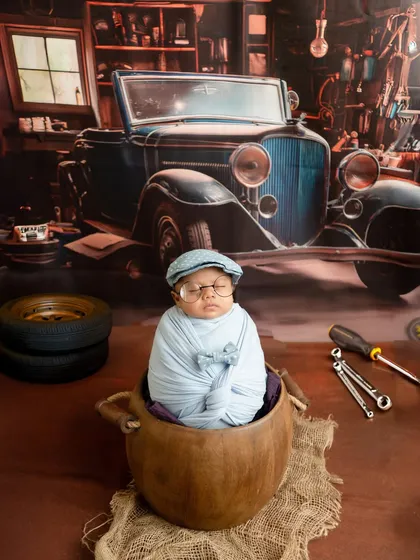A fun and creative setup featuring a baby boy as a vintage mechanic. I have a wide range of props and backdrops in my studio to bring any unique concept to life.
