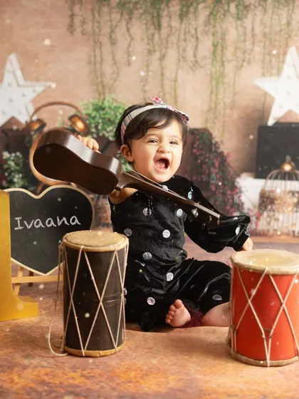 A little rockstar in the making. Letting toddlers play with props like this toy guitar often leads to the most expressive and fun photographs.