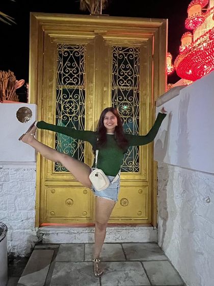 Having fun with a standing split pose at night in Turkey. Yoga can be playful and integrated into all parts of life.